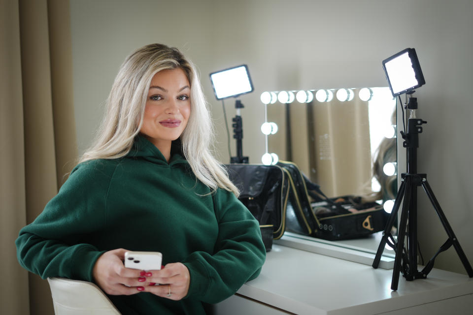 TikToker Allie Pribula poses for a photograph in Mechanicsburg, Pa., Monday, Nov. 20, 2023. More than a decade after debuting on the once-nascent YouTube creator community, “Get Ready with Me” videos have inundated social media. Pribula, a 25-year-old TikToker who used to be an elementary school teacher in the Philadelphia suburbs, says she started making GRWM videos as a way to process her feelings about her old job. (AP Photo/Matt Rourke)