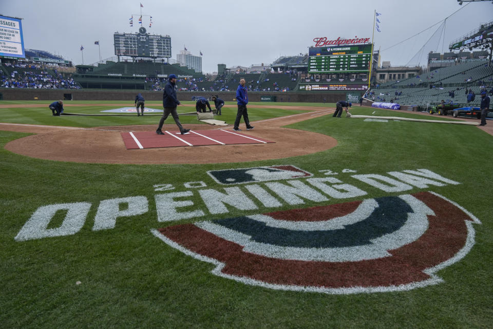 Workers prepare Wrigley Field before an opening day baseball game between the Chicago Cubs and Colorado Rockies Monday, April 1, 2024, in Chicago. (AP Photo/Erin Hooley)
