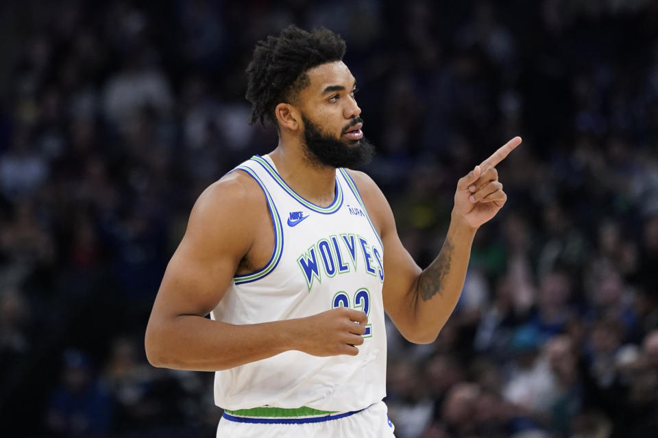 Minnesota Timberwolves center Karl-Anthony Towns points after making a three-point basket during the first half of an NBA basketball game against the New Orleans Pelicans, Wednesday, Nov. 8, 2023, in Minneapolis. (AP Photo/Abbie Parr)