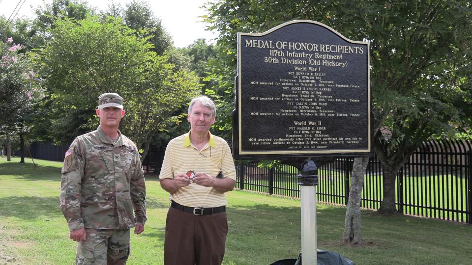 Col. Timothy Schubert of the 278th National Guard Regiment and David Williams of the Pond Gap community stand next to the new historical marker to Medal of Honor recipients from the 117th Infantry Regiment off Sutherland Avenue on July 16, 2023. The community association had placed the marker there.