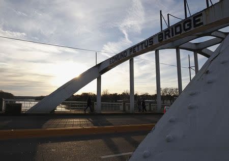 The sun sets along the Edmund Pettus Bridge, in Selma, Alabama March 6, 2015. U.S. President Barack Obama will deliver remarks on the bridge on Saturday to commemorate the 50th anniversary of the Selma to Montgomery civil rights marches. REUTERS/Tami Chappell