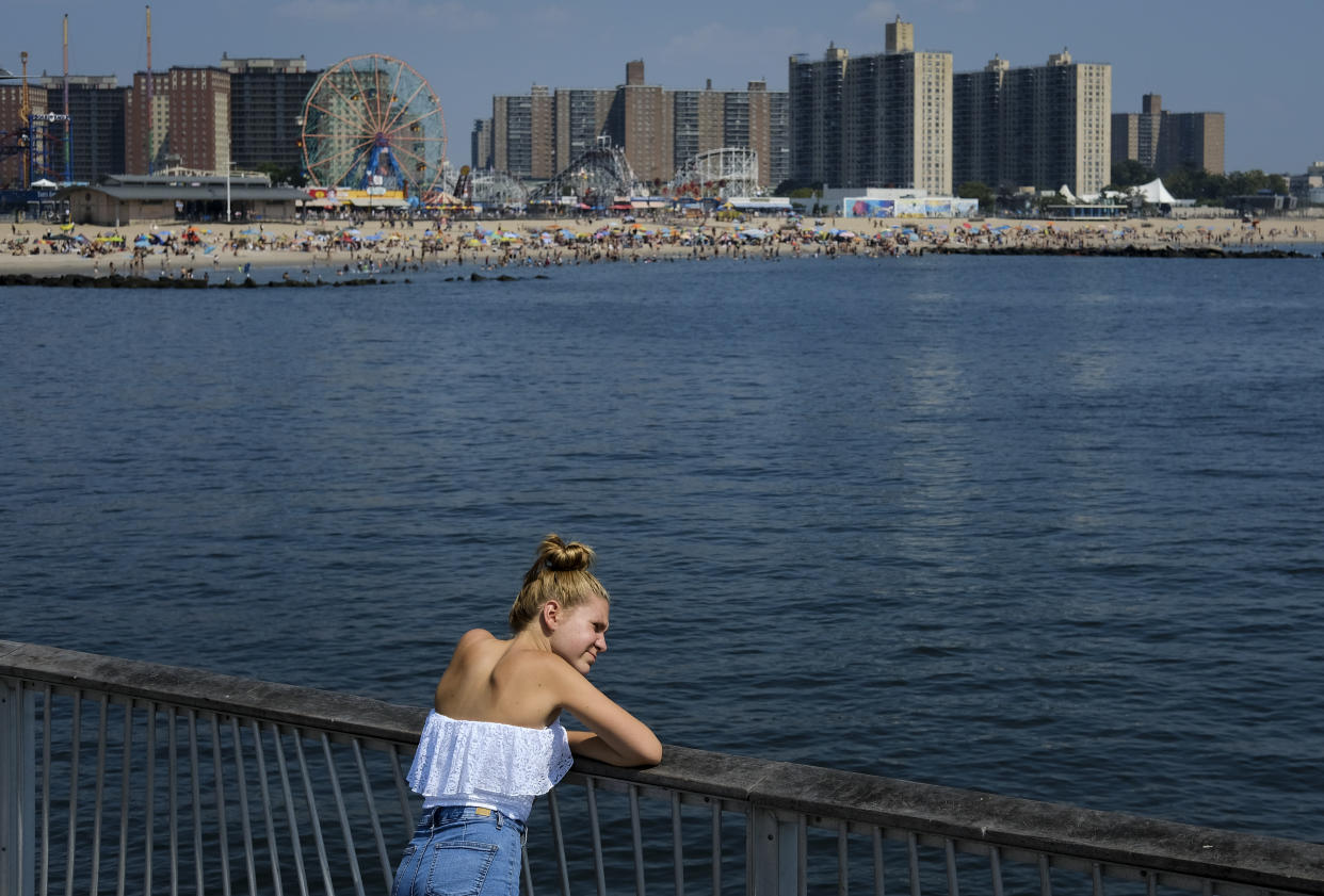 A woman looks out into the water on the fishing pier during a hot afternoon at Coney Island Beach, August 29, 2018 in the Brooklyn borough of New York City. (Photo: Drew Angerer/Getty Images)