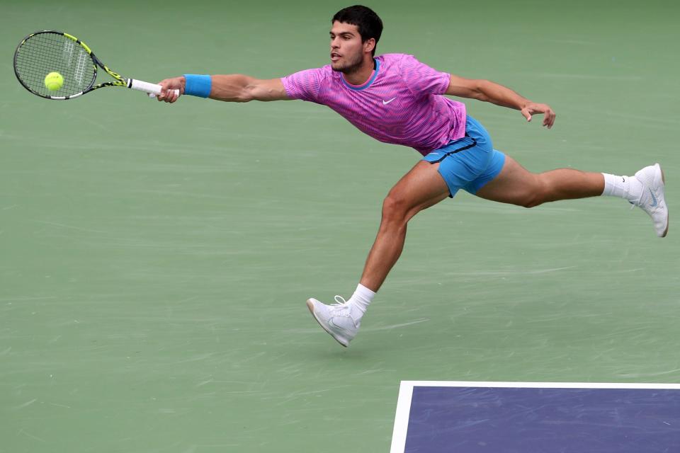 Carlos Alcaraz returns to Daniil Medvedev during their BNP Paribas Open championship match at the Indian Wells Tennis Garden in Indian Wells, Calif., on Sunday, March 17, 2024.