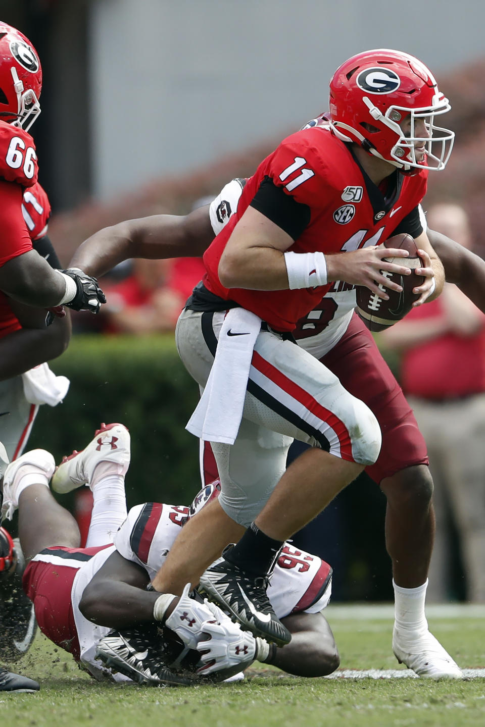 Georgia quarterback Jake Fromm (11) is brought down by South Carolina defensive lineman Kobe Smith (95) in the second half of an NCAA college football game Saturday, Oct. 12, 2019, in Athens, Ga. (AP Photo/John Bazemore)