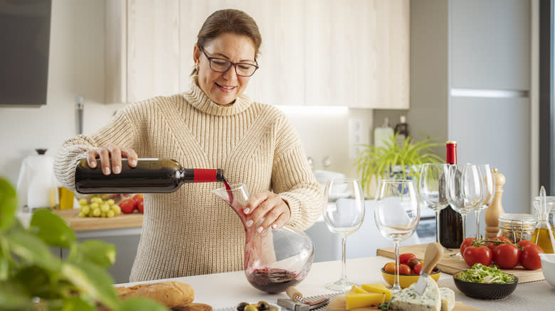 woman pouring wine into decanter