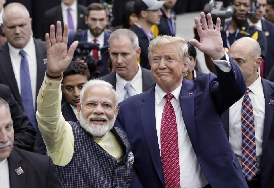 FILE - In this Sept. 22, 2019, file photo, India Prime Minister Narendra Modi and President Donald Trump walk the perimeter of the arena floor to greet attendants after Modi's speech during the "Howdi Modi" event at NRG Stadium in Houston. President Donald Trump is ready for a king's welcome as he head to India on Sunday for a jam packed two-day tour. The visit will feature a rally at one of the world's largest stadiums, a crowd of millions cheering him on and a lovefest with a like-minded leader during an election year. (AP Photo/Michael Wyke, File)