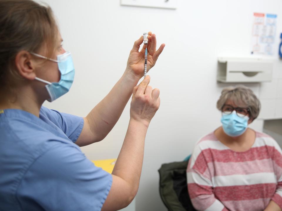 Dr Jess Harvey prepares the Pfizer-BioNTech coronavirus vaccine for injection at the Northgate Health Centre in Bridgnorth (Nick Potts/PA)