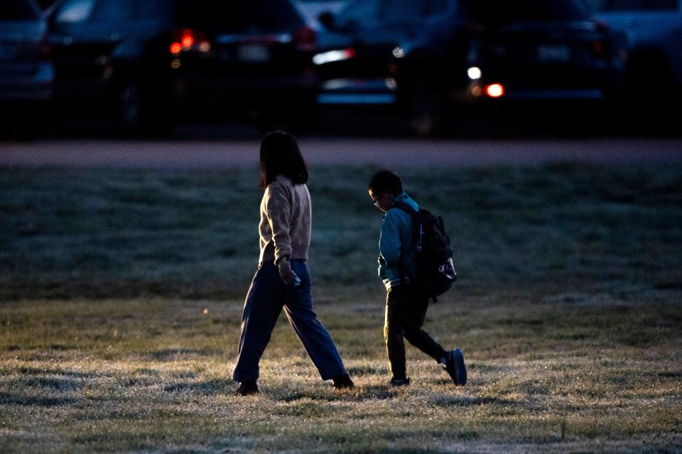 A parent walks their child to the entrance of Hardin Valley Elementary School on Monday after federal judge J. Ronnie Greer suspended his mask rule for Knox County Schools last week.