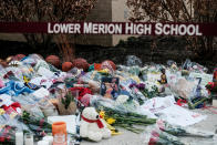 Mourners place flowers outside Bryant Gymnasium at Lower Merion High School to pay their respects after the passing of basketball legend Kobe Bryant, in Philadelphia, U.S. January 27, 2020. (REUTERS/Michael A. McCoy)