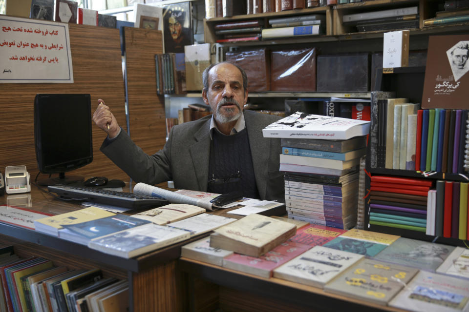 In this Jan. 23, 2019 photo, bookseller Mohsen Fat'hi, a former revolutionary, speaks with The Associated Press about Iran's 1979 Islamic Revolution at his shop, in downtown Tehran, Iran. During the uprising, Fat’hi made gasoline bombs, sold banned books and reprinted pamphlets with statements from Ayatollah Ruhollah Khomenini, the exiled cleric who eventually became the country’s supreme leader. For all the risks Fat’hi took in supporting the revolution, he described himself today as disappointed. (AP Photo/Vahid Salemi)