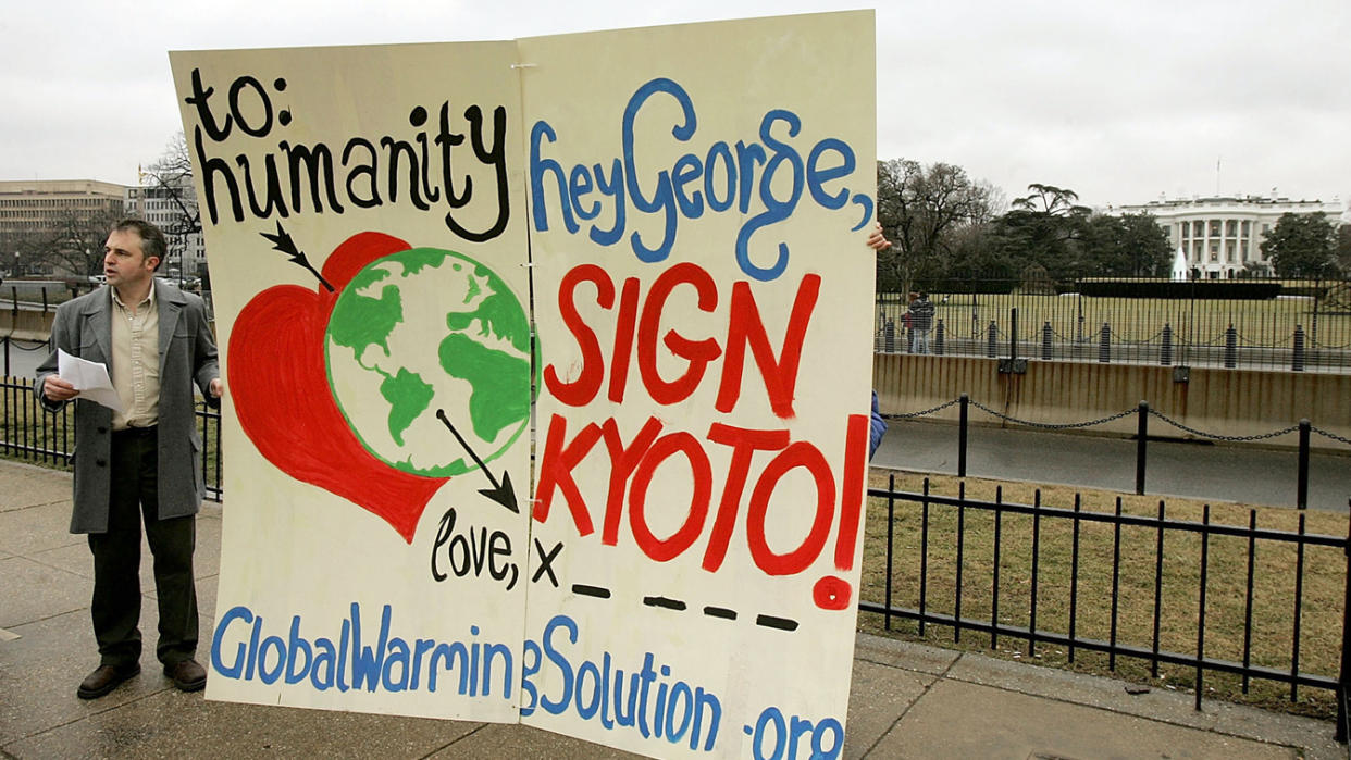 David Merrill Executive Director of the National Global Warming Coalition reads from a paper urging U.S. President George W. Bush to sign the Kyoto Protocol during a protest on the Ellipse behind the White House February 14, 2005 in Washington, DC. (Mark Wilson/Getty Images)