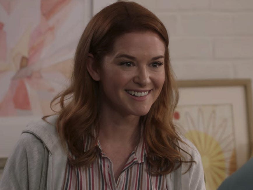 Sarah Drew as April on Greys Anatomy wearing a striped button down and gray jacket