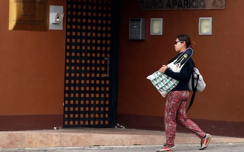 A woman walks past North Korea's embassy in Madrid, Spain - Credit: AP