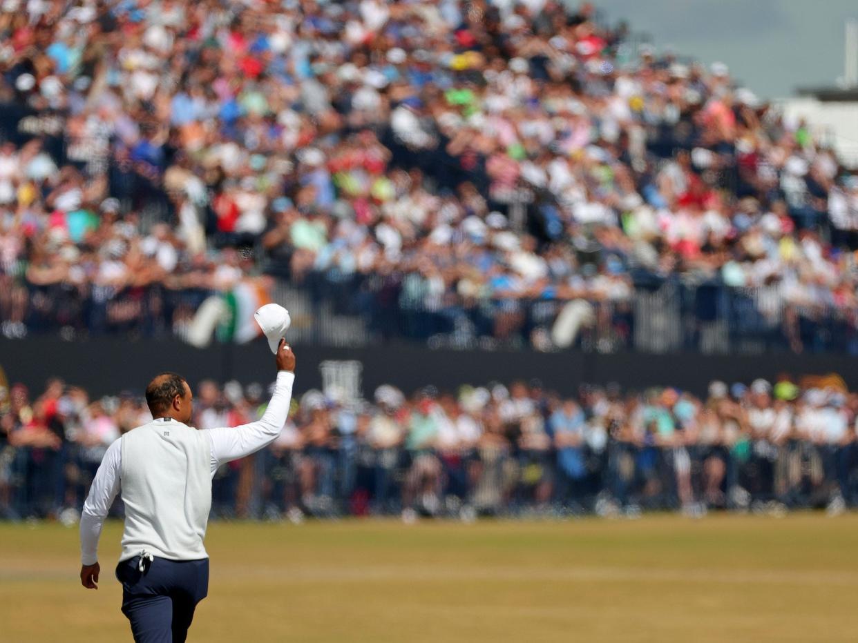 Tiger Woods walks the 18th fairway at the Old Course at St. Andrews.