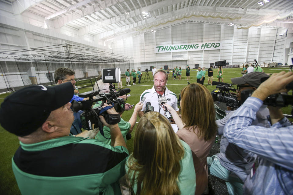 In this Sept. 6, 2014 photo, Chris Cline speaks with media as Marshall University dedicates the new indoor practice facility as the Chris Cline Athletic Complex in Huntington, W.Va. Police in the Bahamas say a helicopter flying from Big Grand Cay island to Fort Lauderdale has crashed, killing seven Americans on board. None of the bodies recovered from the downed helicopter have been identified, but police Supt. Shanta Knowles told The Associated Press on Friday, July 5, 2019, that the missing-aircraft report from Florida said billionaire Chris Cline was on board. (Sholten Singer/The Herald-Dispatch via AP)