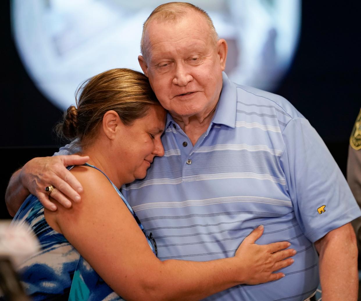 Michael Gallaway, the husband of Margaret Gallaway, hugs his daughter Mary during an update on Margaret Gallaway, who was found six days after being declared missing, at the Collier County Sheriff's Office in Naples on Monday, Oct. 23, 2023.