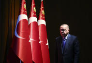 Turkey's President Recep Tayyip Erdogan arrives to deliver a speech at an event in Ankara, Turkey, Monday, Dec. 30, 2019. Turkey's government on Monday submitted a motion to parliament seeking approval to deploy troops to Libya, to help authorities in Tripoli defend the city from an offensive by rival forces, arguing that the conflict in the North African country could escalate into a civil war and threaten Turkey's interests. (Presidential Press Service via AP, Pool)