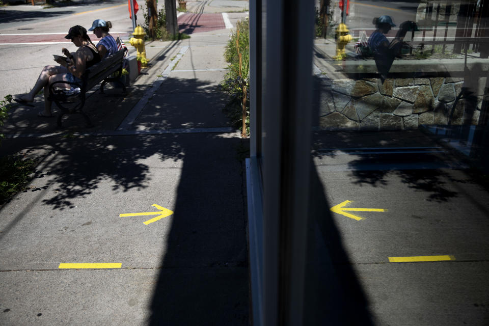 Tape marks social distance spots for customers outside one of two Brickley's Ice Cream shops which closed for the season after teenage workers were harassed by customers who refused to wear a mask or socially distance, in Wakefield, R.I., Wednesday, July 29, 2020. Disputes over masks and mask mandates are playing out at businesses, on public transportation and in public places across America and other nations. (AP Photo/David Goldman)