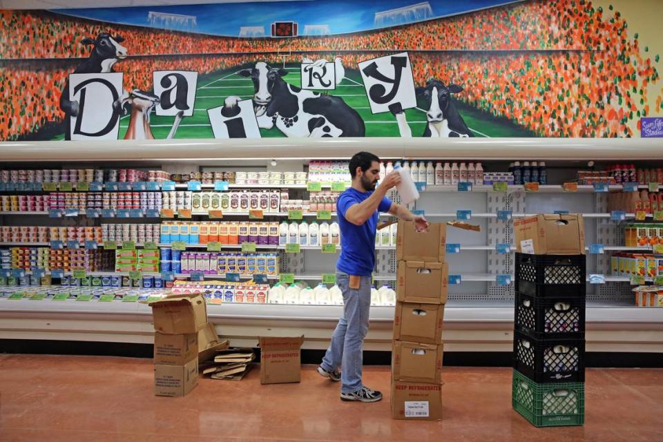 A crew member stocks dairy products during a preview of the new Trader Joe’s in Pinecrest in 2013.