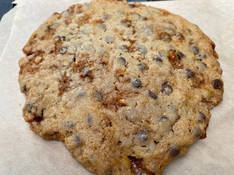 A giant cookie on a baking sheet.