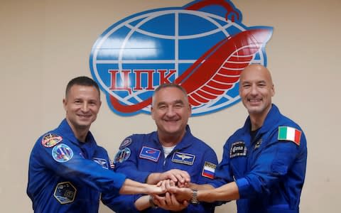 NASA astronaut Andrew Morgan, Alexander Skvortsov of the Russian space agency Roscosmos and Luca Parmitano of European Space Agency (ESA) pose after their final news conference ahead of their launch to the International Space Station (ISS), at the Baikonur Cosmodrome, Kazakhstan, July 19, 2019 - Credit: Reuters