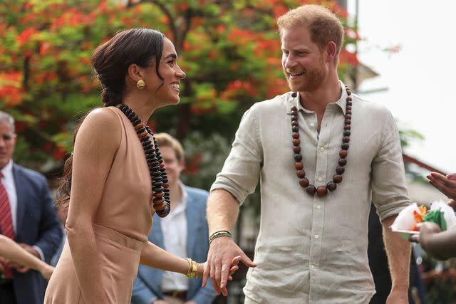 <p>KOLA SULAIMON/AFP via Getty</p> Britain's Prince Harry (R), Duke of Sussex, and Britain's Meghan (L), Duchess of Sussex, arrive at the Lightway Academy in Abuja on May 10, 2024 as they visit Nigeria as part of celebrations of Invictus Games anniversary.