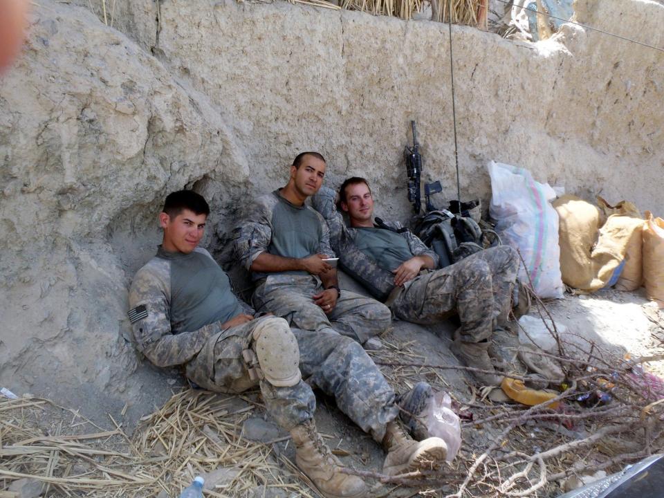 William Yeske, far right, and fellow paratroopers Rudy "Doc" Ponce and Hector Trujillo take a break at a patrol base right before a firefight during a 2010 deployment to Afghanistan.