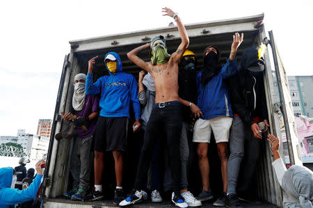 Demonstrators are seen on a truck during a protest by opposition supporters against Venezuelan President Nicolas Maduro's government in Caracas, Venezuela January 23, 2019. REUTERS/Carlos Garcia Rawlins