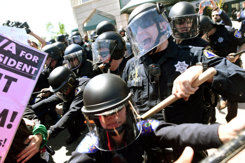 <p>Police in riot gear hold back demonstrators against U.S. Republican presidential candidate Donald Trump outside the Hyatt hotel where Trump was set to speak at the California GOP convention in Burlingame, Calif., on April 29, 2016. <i>(Noah Berger/Reuters)</i></p>