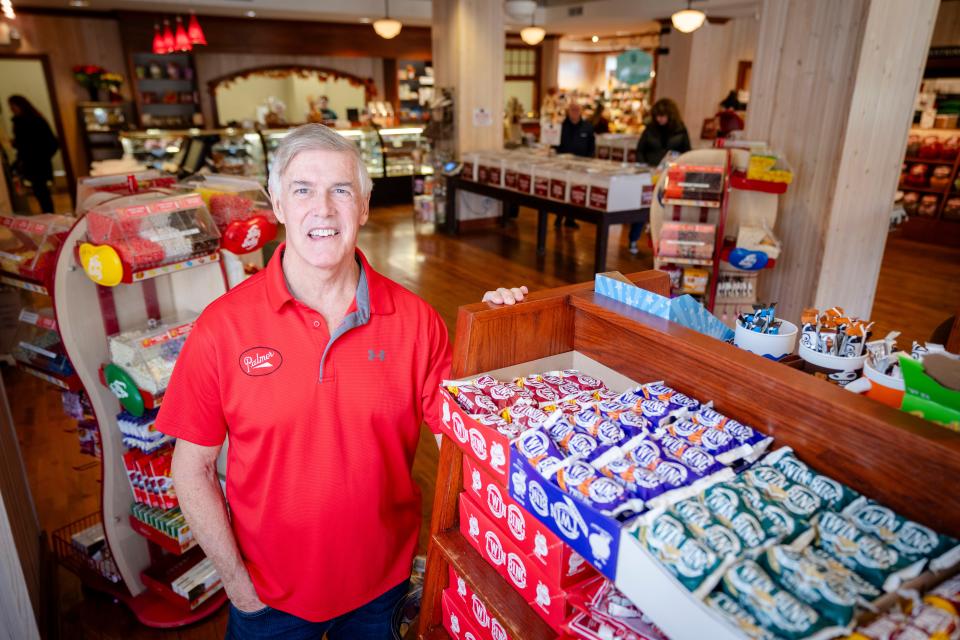 Marty Palmer, President of Palmer Candy stand for a photo with the Twin Bing selection at the Palmer's Olde Tyme Candy Shoppe.