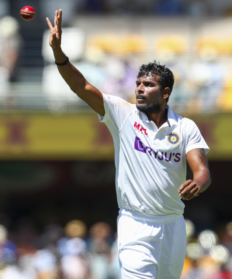 India's Thangarasu Natarajan reaches to catch the ball during play on the first day of the fourth cricket test between India and Australia at the Gabba, Brisbane, Australia, Friday, Jan. 15, 2021. (AP Photo/Tertius Pickard)