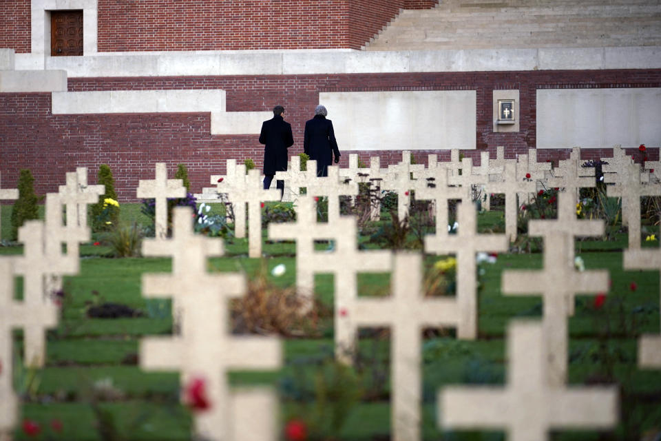 British Prime Minister Theresa May and French President Emmanuel Macron walk after a wreath-laying ceremony at the Thiepval cemetery as part of ceremonies to mark the centenary of the 1918 Armistice, in Thiepval, northern France, Friday, Nov. 9, 2018. The memorial commemorates more than 72,000 men of British and South African forces who died in the Somme offensive of 1916. (Christopher Furlong/Pool Photo via AP)