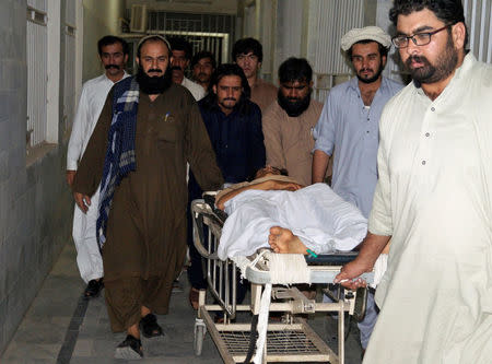 People move a stretcher with an injured man, who was shot after militants attacked on a jirga (tribal assembly or public meeting) organised by the ethnic rights group Pashtun Tahaffuz Movement (PTM) in Wana, the main town in Pakistan's South Waziristan tribal region bordering Afghanistan, in early morning at a hospital in Dera Ismail Khan, Pakistan June 4, 2018. REUTERS/Stringer