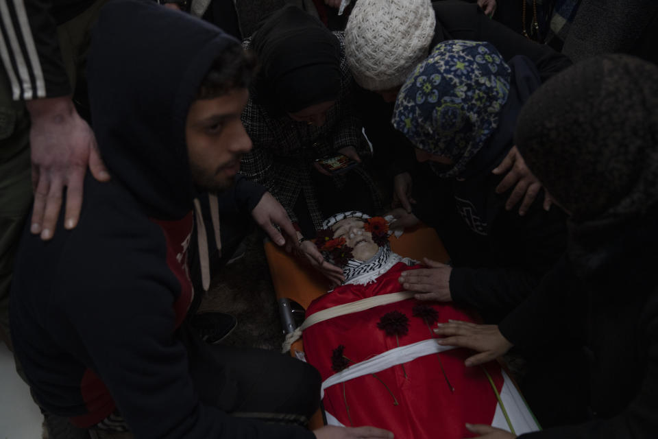 Mourners take a last look at the body of Mohammad Khdour, 17, at his family's house during his funeral in the West Bank village of Biddu, southwest of Ramallah, Monday, Feb. 12, 2024. Khdour, a U.S. citizen born in Florida, was shot Saturday while driving with a cousin on a hillside by what his family alleges was Israeli fire. The family say U.S. embassy officials have visited the home to investigate. (AP Photo/Nasser Nasser)