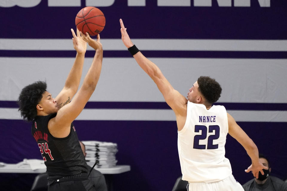 Rutgers guard/forward Ron Harper Jr., left, shoots against Northwestern forward Pete Nance during the second half of an NCAA college basketball game in Evanston, Ill., Sunday, Jan. 31, 2021. (AP Photo/Nam Y. Huh)