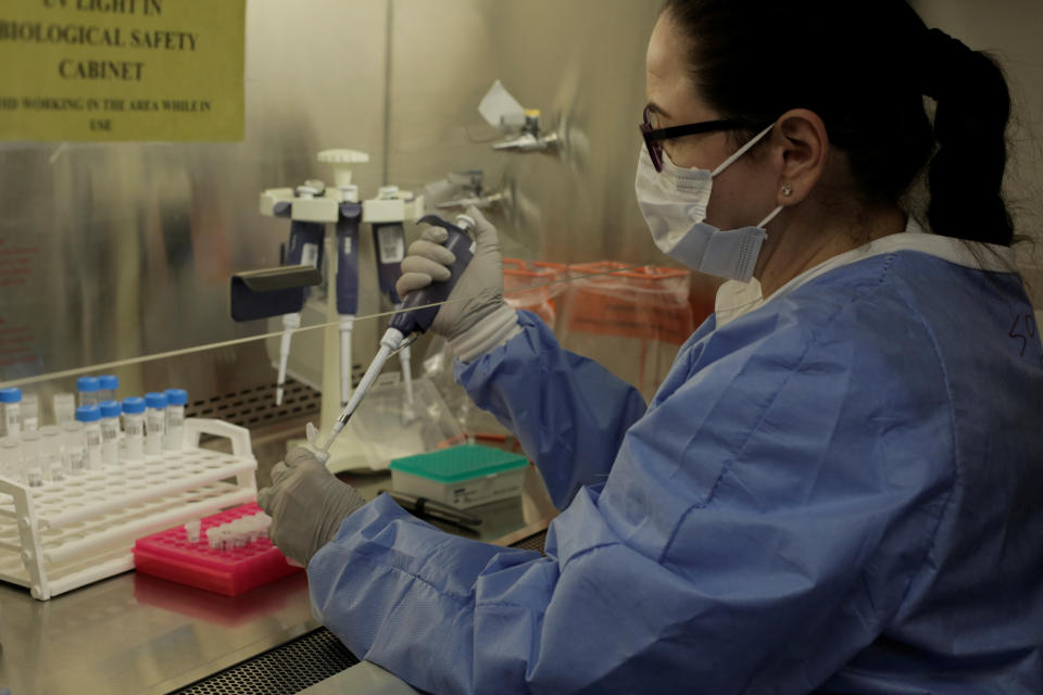 Microbiologist Milagros Sola processes coronavirus disease (COVID-19) tests in a lab at Madigan Army Medical Center at Joint Base Lewis-McChord, Washington, U.S. April 14, 2020. REUTERS/David Ryder
