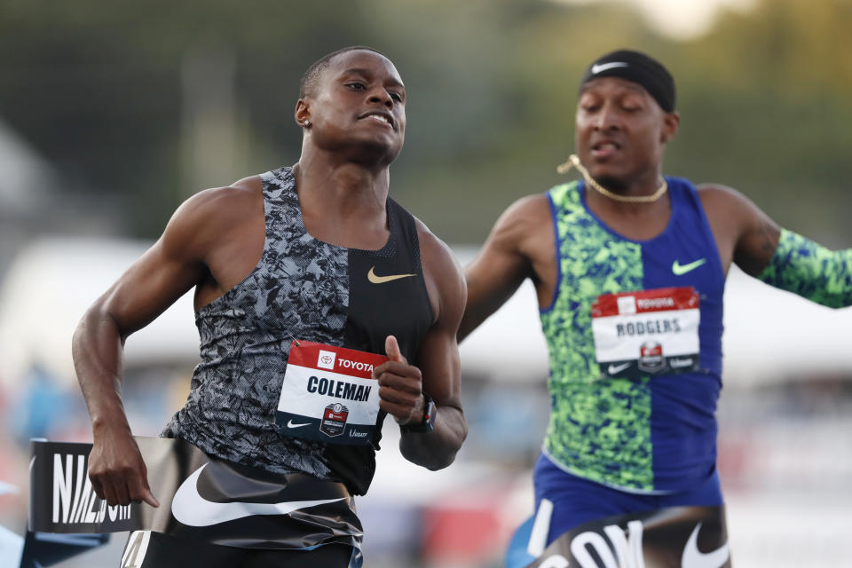 Christian Coleman reacts in front of Michael Rodgers, right, as he wins the men's 100-meter dash final at the U.S. Championships athletics meet, Friday, July 26, 2019, in Des Moines, Iowa. (AP Photo/Charlie Neibergall)