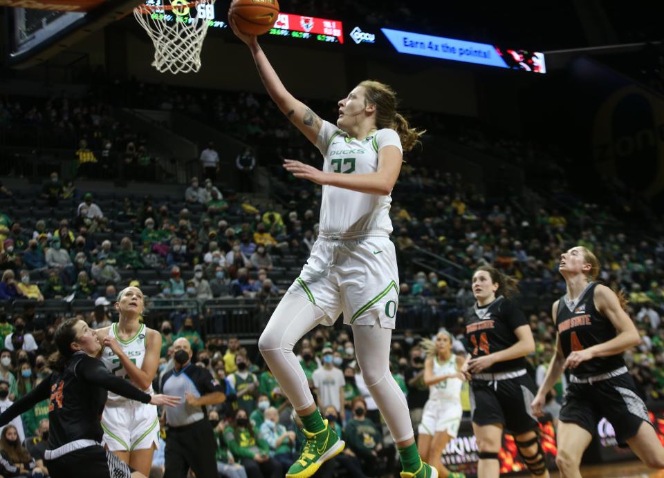 Oregon's Sedona Prince, center, goes up for a shot during the second half against  Idaho State.