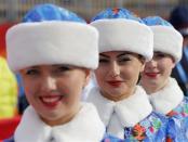 Hostesses attend the flower ceremony during the men's alpine skiing Super-G competition during the 2014 Sochi Winter Olympics at the Rosa Khutor Alpine Center February 16, 2014. REUTERS/Leonhard Foeger