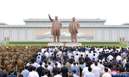 People and soldiers gather to offer flowers to the statues of state founder Kim Il Sung and former leader Kim Jong Il on the Day of Songun at Mansu hill, Pyongyang, North Korea, in this undated photo released by North Korea's Korean Central News Agency (KCNA) on August 26, 2018. KCNA via REUTERS