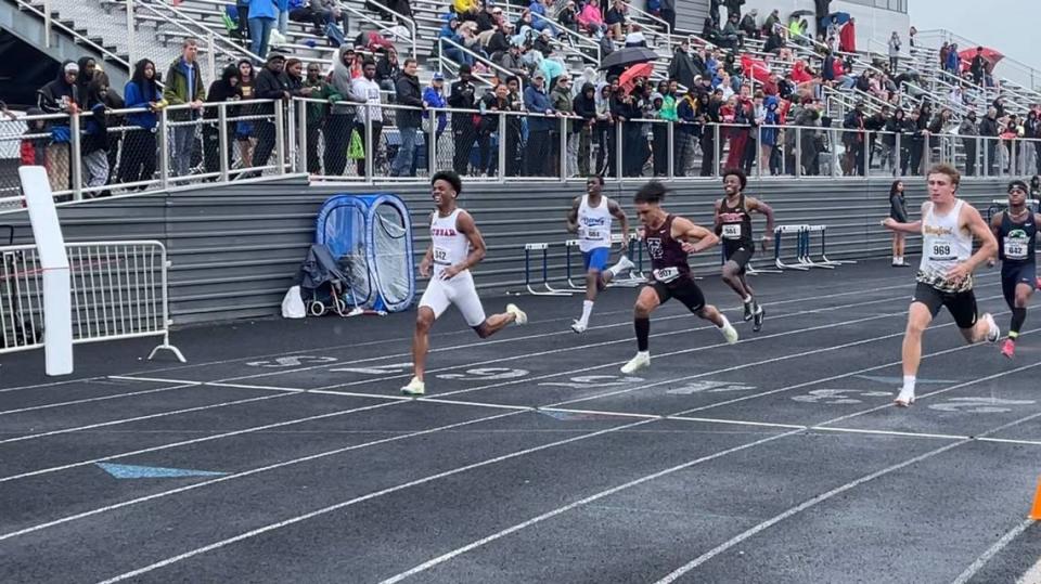 Paul Laurence Dunbar’s Kaylib Nelson crosses the finish line first in the 100 meters Saturday. Nelson also won the 200 and anchored the Bulldogs’ victory in the 4-by-100 relay.