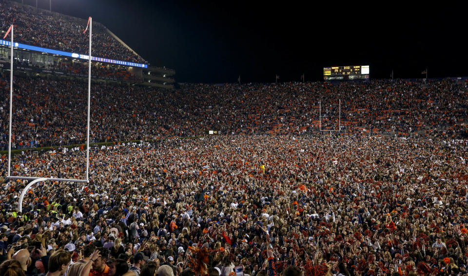 Auburn fans storm the field to celebrate the win over Alabama after the Iron Bowl, and they caused some seismic ground noise at the same time. (AP Photo)