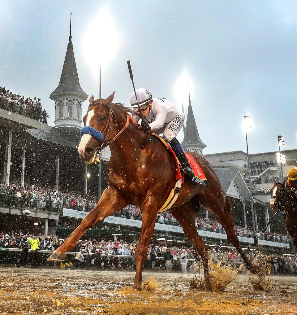Finish line lights illuminate Justify, and jockey Mike Smith as they cross the finish line at Churchill Downs in a driving rain to win the 144th running of the Kentucky Derby and the first leg of the Triple Crown.May 5, 2018