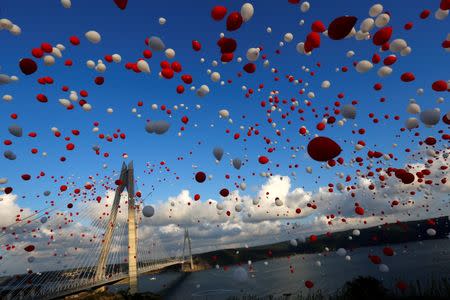 Red and white balloons are released during the opening ceremony of newly built Yavuz Sultan Selim bridge, the third bridge over the Bosphorus linking the city's European and Asian sides in Istanbul, Turkey, August 26, 2016. REUTERS/Murad Sezer