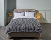 <p>Get cosy this festive season with Aldi's grey knit throw. It's perfect for adding an extra layer of comfort to your bed, sofa or armchair. This will be available to buy online from 15th November.</p>