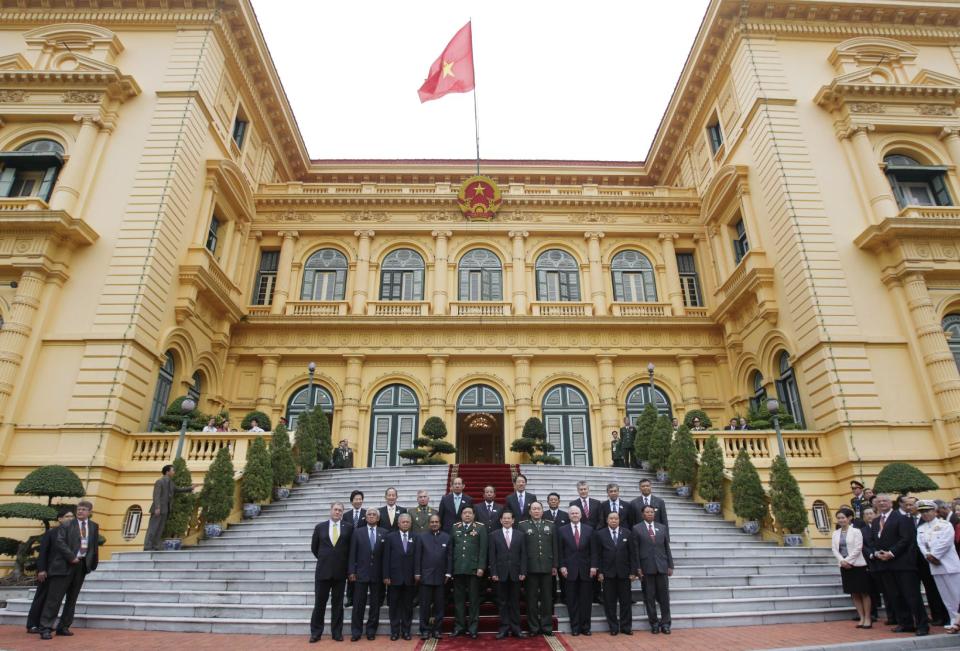 FILE - This Oct. 12, 2010 file photo shows Defense ministers, U.S. Defense Secretary Robert Gates, front row third from fight, and Vietnam president Nguyen Minh Triet, front row fifth from right, gather to be photographed on the front steps of the Presidential Palace during the Association of Southeast Asian Nations Defense Minister' Meeting Retreat in Hanoi, Vietnam. The stately Presidential Palace near Ho Chi Minh's mausoleum is an example of French colonial-style architecture. (AP Photo/Carolyn Kaster, Pool)