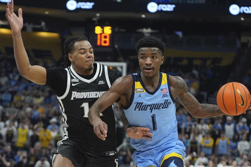 Marquette's Kam Jones tries to get past Providence's Jayden Pierre during the first half of an NCAA college basketball game Wednesday, Feb. 28, 2024, in Milwaukee. (AP Photo/Morry Gash)