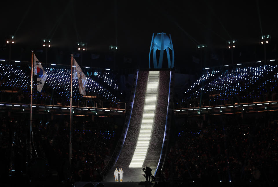 North Korea’s Jong Su Hyon, left, and South Korea’s Park Jong-ah carry the Olympic torch. (AP)