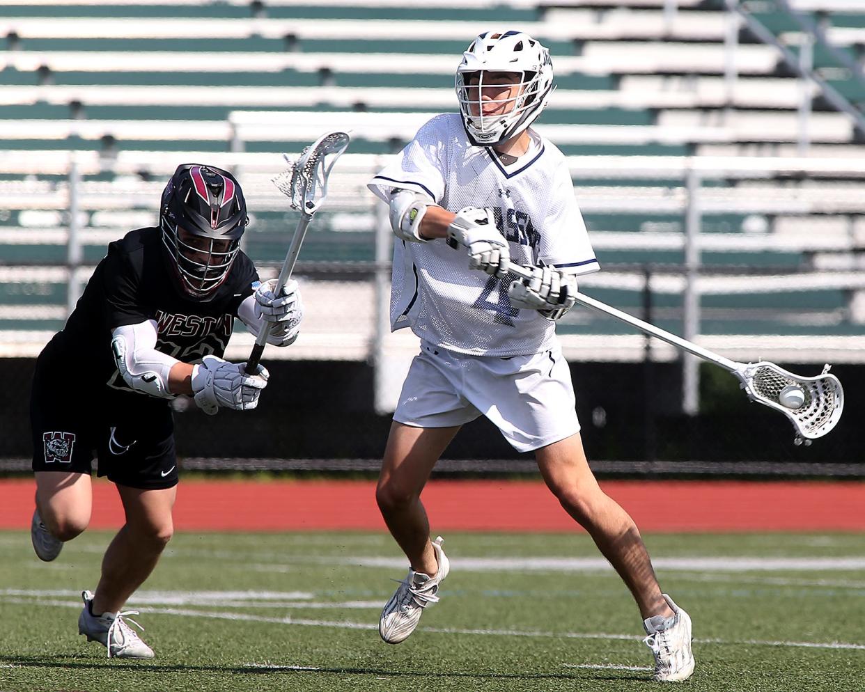 Cohasset's Shane Mulcahy fires a shot on goal during first quarter action of their game in the Division 4 state semifinal game against Weston at Weymouth High School on Thursday, June 15, 2023. 