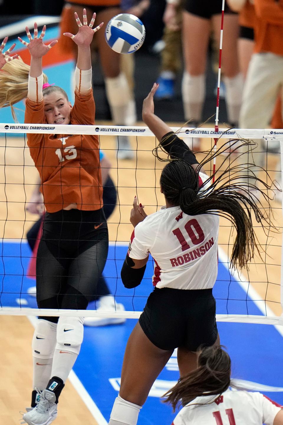 Texas outside hitter Jenna Wenaas, left, blocks a shot by Wisconsin's Devyn Robinson in the 3-1 win over Wisconsin Thursday night in Tampa, Fla. With the win, Texas advances to face Nebraska in Sunday's national championship.